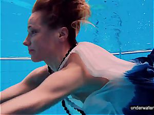 teenager female Avenna is swimming in the pool